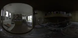 360-degree HDR panorama of an artist's workspace with shelves of supplies for scene lighting.