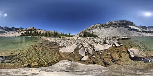 360-degree view of a clear sunny day at a rocky lakeside with vibrant blue skies for HDR lighting.