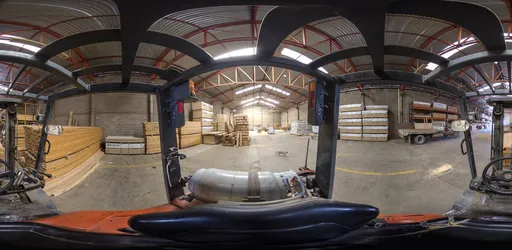 High-resolution industrial warehouse interior HDR from forklift perspective, featuring lumber stacks.