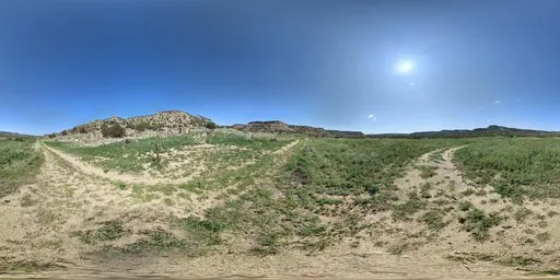 360-degree HDR panorama of a dry mud road leading through a mountainous landscape under a clear blue sky.