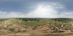 360-degree HDR panorama for scene lighting, featuring rocky foreground and cloudy sky.