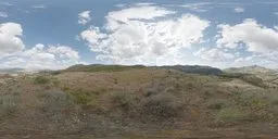 High-resolution HDR panorama of a sunny field with dynamic clouds for realistic lighting in 3D scenes.