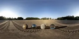 Golden-hour 17k HDR panorama featuring a realistic sunlit farm field with multiple exposure spheres and a distant treeline.