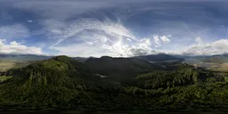 360-degree panoramic HDR featuring expansive mountainous terrain under a dynamic cloudy sky.