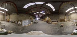 Interior panorama of a spacious lumber warehouse with stacked timber, forklift, and industrial racks.