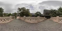 HDR image of a cobblestone path leading to a stone bridge with greenery under a cloudy sky for scene lighting.