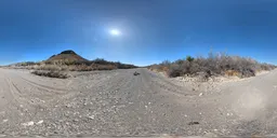 High-resolution 16k HDR panorama with vivid blue sky, scattered clouds, and a natural rocky landscape with sparse trees.