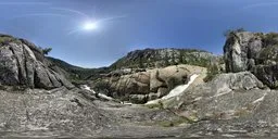 360-degree HDR panorama of a mountainous landscape with clear blue sky and bright sun ideal for scene lighting.