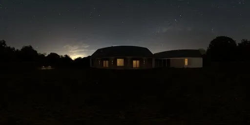 12K night-time HDR panorama of a house with illuminated windows, lush lawn, trimmed hedges, and purple flowers.
