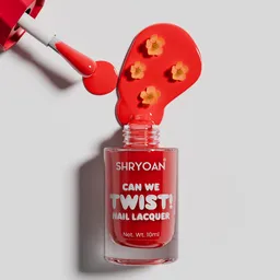 Nail enamel spilled with flowers shot