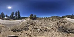 360-degree panoramic HDR scenery with clear blue sky over rocky mountain terrain.