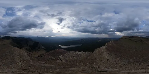Dynamic range lighting panorama with dramatic clouds over rugged terrain for scene illumination.