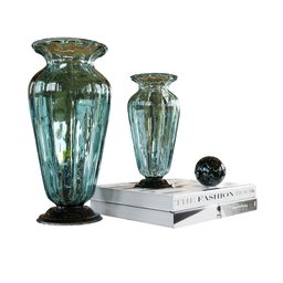 "Blue Murano vases and books on a black marble stack, beautifully crafted in Blender 3D. Perfect for enhancing living spaces and leisure environments. Discover this elegant decorative set with crisp details and iridescent accents."
