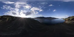Elevated sunset HDR panorama over a serene lake with surrounding mountains for scene lighting.