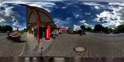 High-quality 360-degree HDRI of a German motorcycle market with clear blue sky and dynamic clouds.