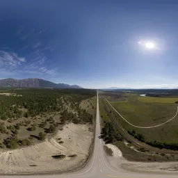 Aerial road & mountains sunny