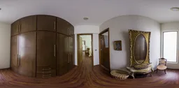 Interior HDR panorama of a well-lit dressing room with wooden furniture and artwork.