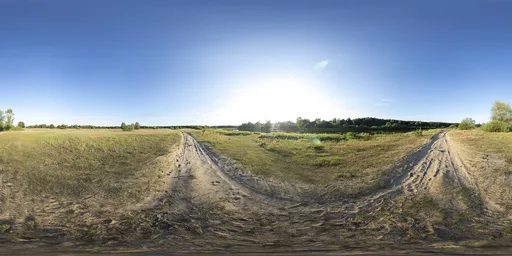 16k unclipped HDR image of a sunset-lit sandy road in a grassy landscape for realistic scene lighting.