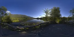 Sunny lakeside HDR panorama for realistic lighting, with clear skies and reflective water surrounded by lush greenery.