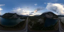Dramatic sunrise over a mountainous highway and lake, ideal for scene lighting HDR.