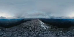 High-resolution 17k HDR image featuring snowy mountain peaks under a dramatic cloudy sky at sunset for scene lighting.