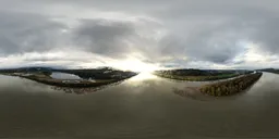 River landscape HDR panorama with sun peering through clouds for scene lighting.