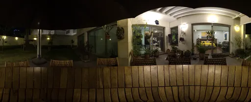 Nighttime HDR image of a cozy terrace with lighting, suitable for scene illumination.