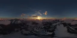 Sunset illuminating clouds over snowy mountains for scene lighting