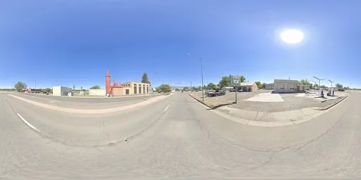 360-degree spherical HDR image featuring a sunlit urban highway with clear blue skies for scene lighting.