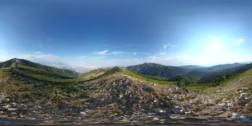 360-degree mountainous landscape HDR for realistic lighting in 3D scenes, featuring a clear blue sky and rocky terrain.