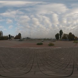 360-degree HDR panorama of a cloudy sky and round paved area with trees for realistic scene lighting.