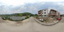 360-degree HDR image capturing urban street scene, buildings, car, and clear blue sky for realistic lighting.