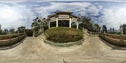 Spherical HDR image featuring a park entrance with a pavilion, lush greenery, and clear skies for scene lighting.