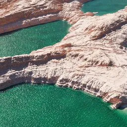 3D-rendered desert coastline with crystal-clear turquoise waters, ideal for creative Blender modeling.