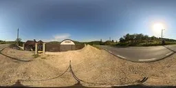 Clear blue sky HDRI for natural lighting in 3D scenes, featuring a serene landscape with a warehouse and gravel pile.