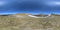 Detailed HDR panorama featuring expansive mountain terrain under a vivid blue sky with radiant sunlight.