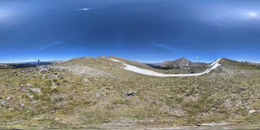 Detailed HDR panorama featuring expansive mountain terrain under a vivid blue sky with radiant sunlight.