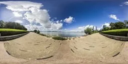 Panoramic seaside HDR environment with clear skies for 3D scene lighting.