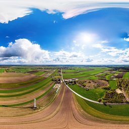Vibrant high dynamic range panorama of farmland with diverse crop fields under a cloudy blue sky, perfect for scene lighting.