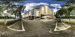 Spherical HDR image showing urban roadside with footpath, buildings, clear morning sky, and vehicles.