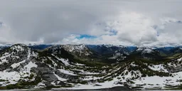 Aerial HDR panorama of snowy mountains with clouds for realistic scene lighting.