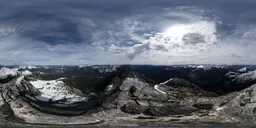 360-degree HDR panorama of a mountaintop with dynamic clouds and sunlight for scene lighting.