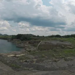 Cloudy sky over a serene quarry with lush greenery, ideal for realistic lighting in 3D scenes.