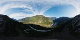 360-degree HDR panorama featuring a river winding through a lush valley surrounded by mountains for scene lighting.