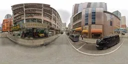 360-degree HDR panorama of an overcast urban street scene with buildings, cars, and subtle reflections for realistic lighting.