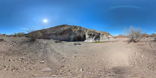 16k HDR panorama of a mountain with clear blue sky, clouds, rocky terrain, and ground textures for realistic scene lighting.