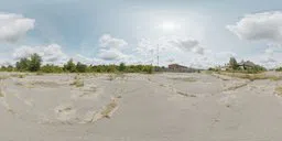360-degree HDR panorama of an overgrown, desolate parking lot with clear skies for realistic scene lighting.