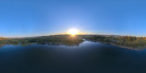 360-degree HDR panorama of sunset over a scenic lake surrounded by trees with clear skies for realistic lighting.