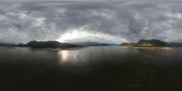 360-degree HDR panorama for scene lighting with reflective lake waters under a stormy sky.