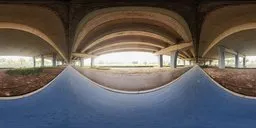 360-degree HDR panorama under a viaduct with clear skies, concrete pillars, and natural terrain.